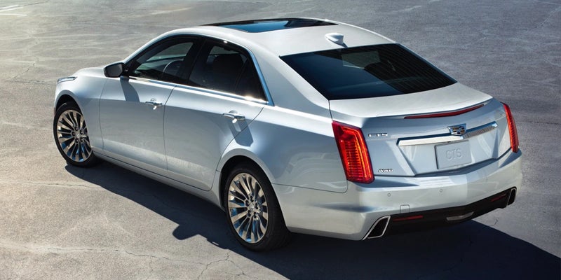 Rear view of silver Cadillac CTS parked on pavement